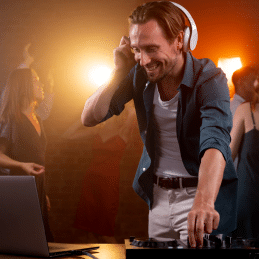 Male Dj smiling and playing music